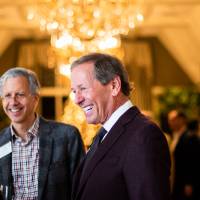 Dan DeVos laughing with guests.